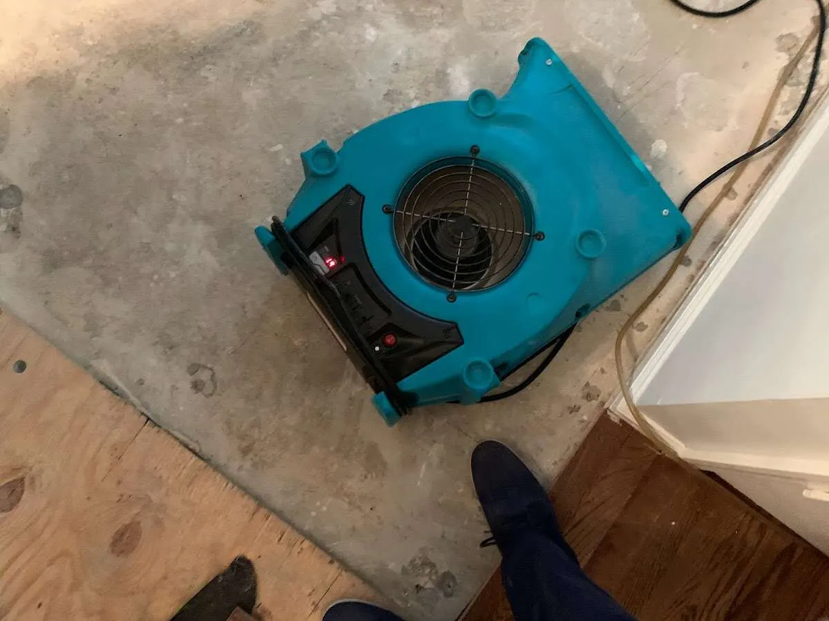 Air mover drying subfloor during Commercial Water Damage Restoration in DeSoto